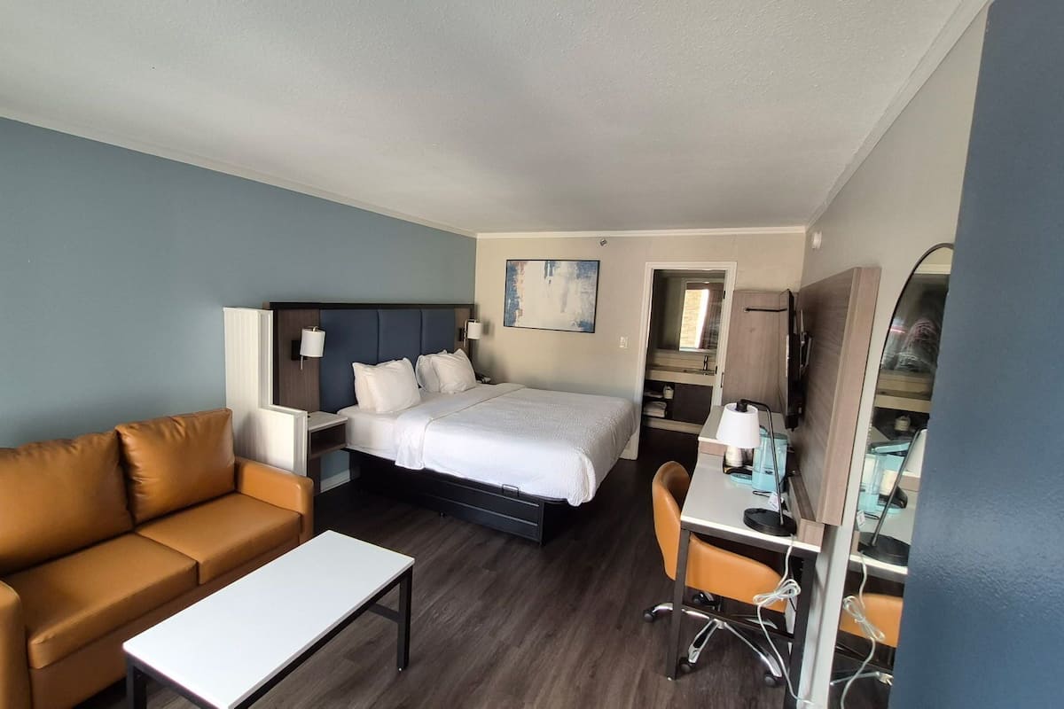 Suite, 1 King Bed, Non Smoking | Desk, laptop workspace, blackout drapes, iron/ironing board