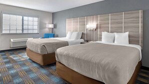 A hotel room with two beds, a large window, a standing lamp, and a patterned carpet. - Quality Inn & Suites Fort Madison near Hwy 61 (Fort Madison)