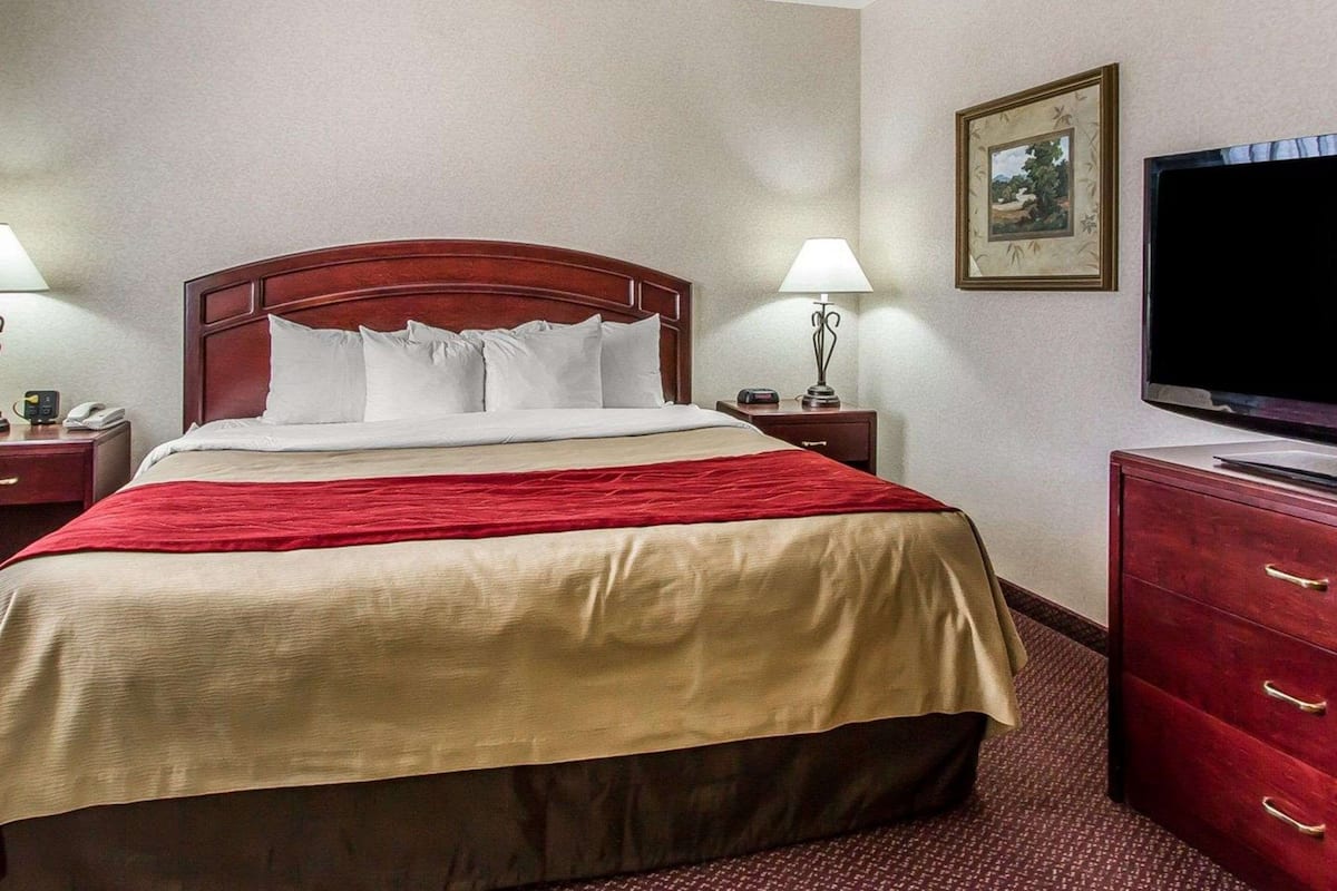 Premium bedding, desk, laptop workspace, iron/ironing board