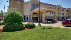 A hotel with a prominent sign reading "Comfort Suites."