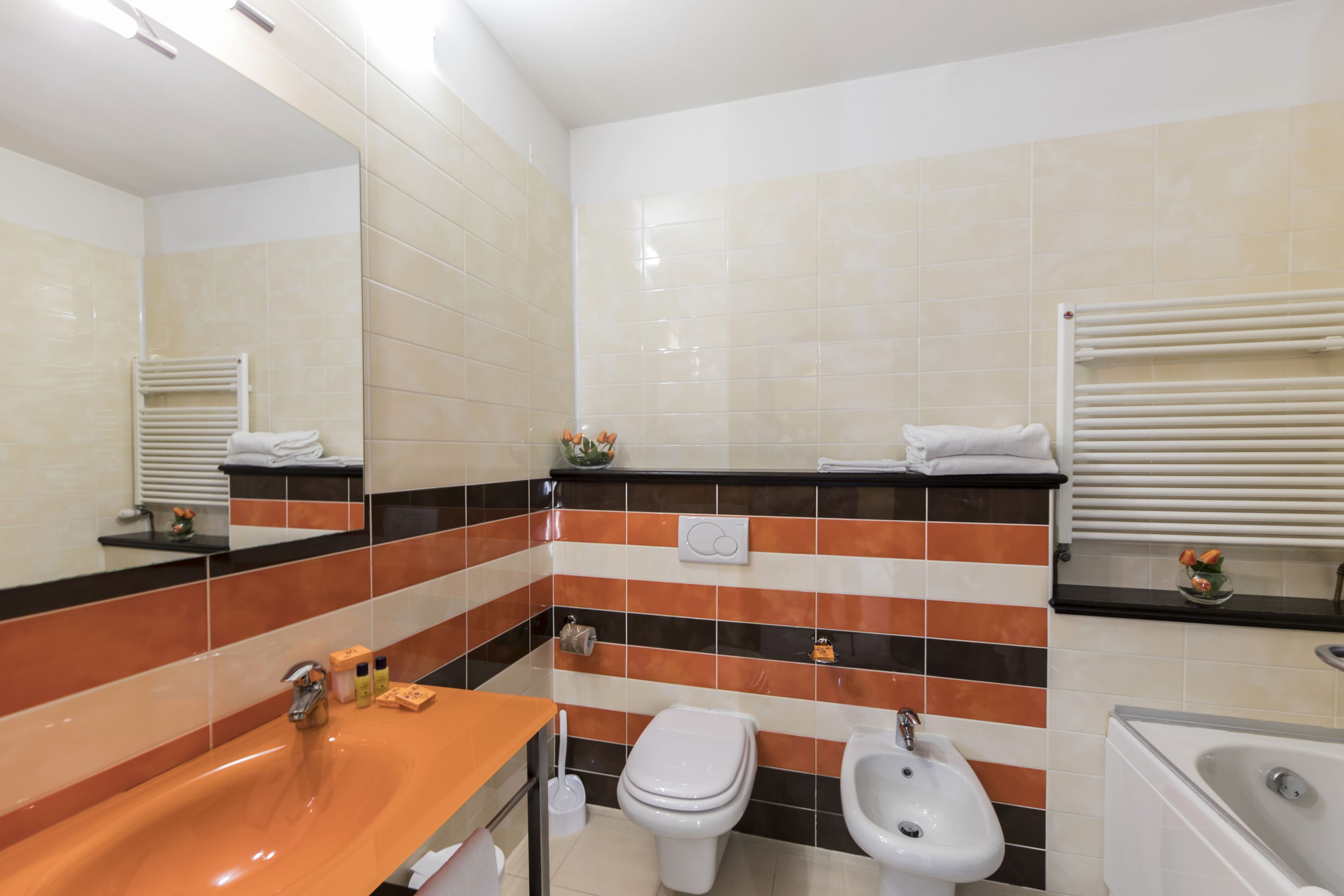 Ein Badezimmer mit Waschbecken, Toilette, Bidet und Badewanne.