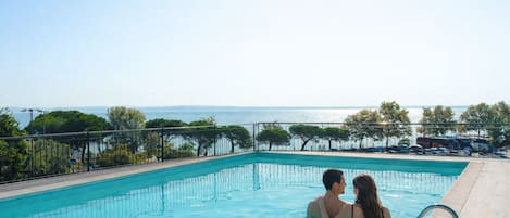 Seasonal outdoor pool, open 9:00 AM to 7:00 PM, pool umbrellas