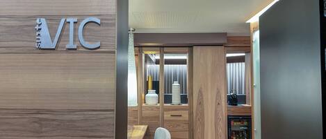 A modern interior with a wooden wall and a sign reading "VIC".