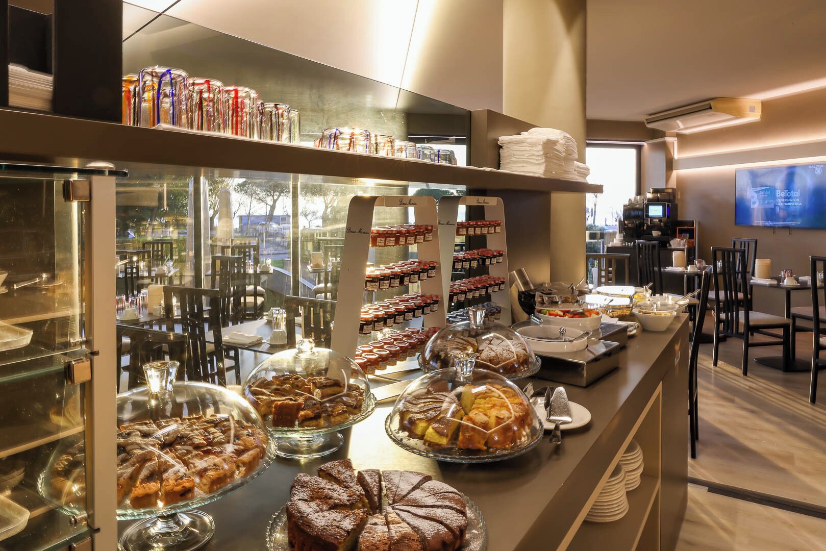 A buffet area with various food items displayed in glass cases and on serving platters.
