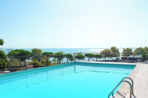 Seasonal outdoor pool, open 10:00 AM to 7:00 PM, pool umbrellas