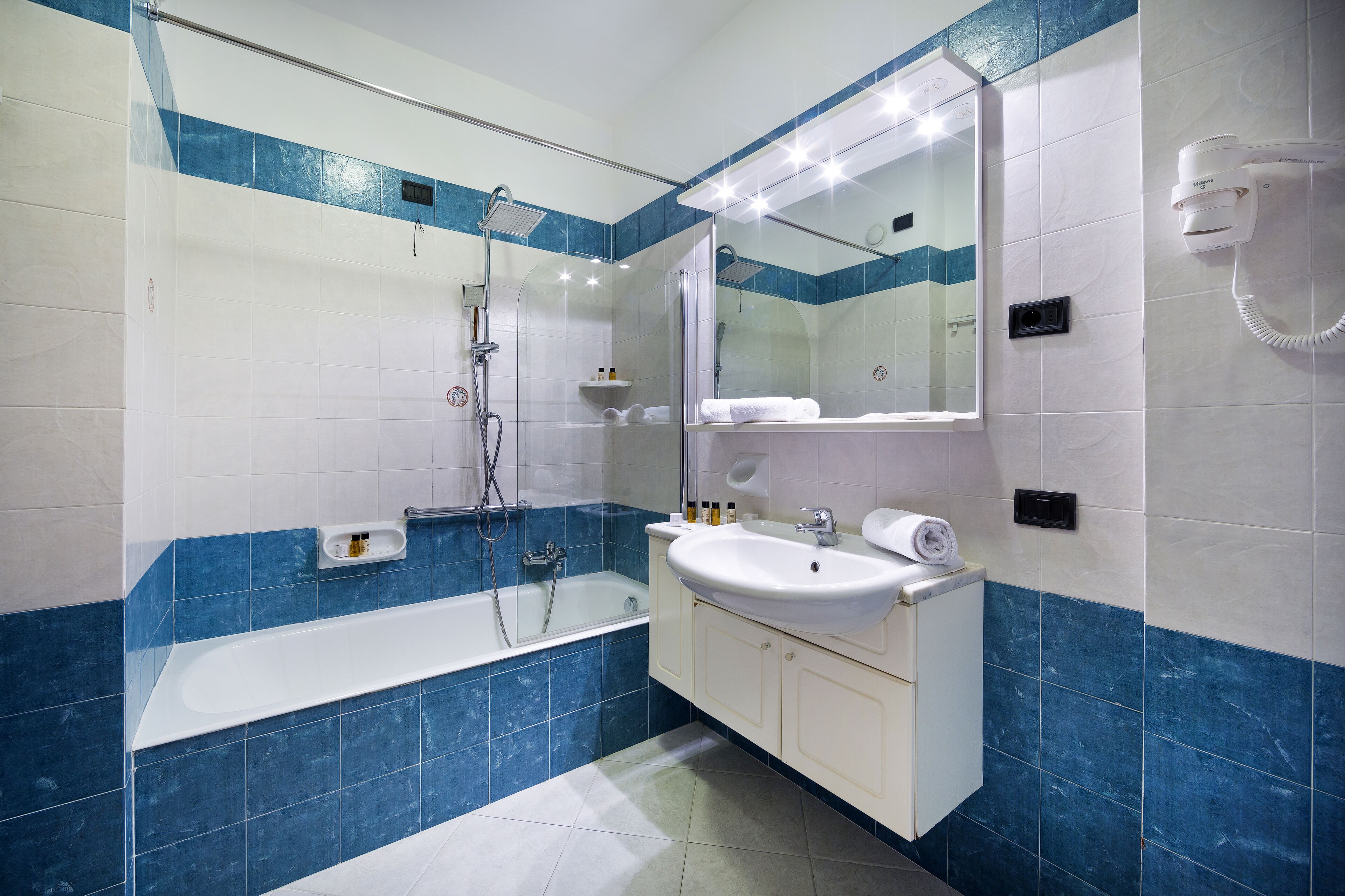 bathtub, eco-friendly toiletries, hair dryer, slippers