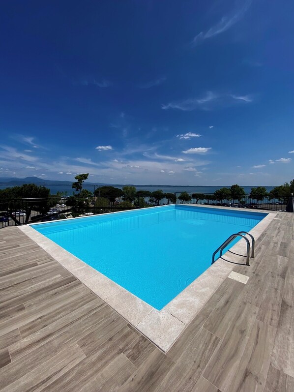Seasonal outdoor pool, open 10:00 AM to 7:00 PM, pool umbrellas