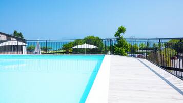 Seasonal outdoor pool, open 9:00 AM to 7:00 PM, pool umbrellas