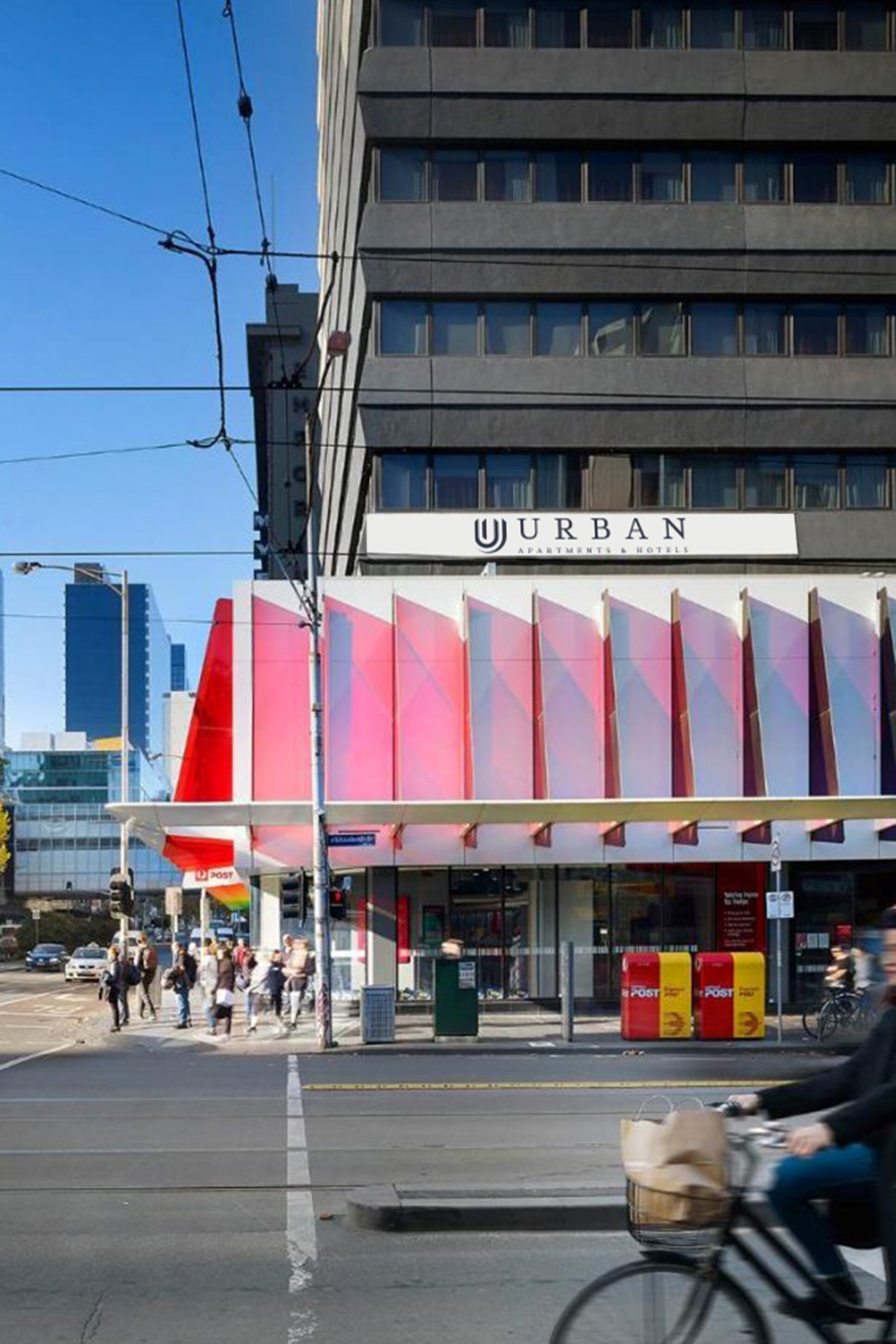 A building with a sign that reads "URBAN Apartments & Hotels".
