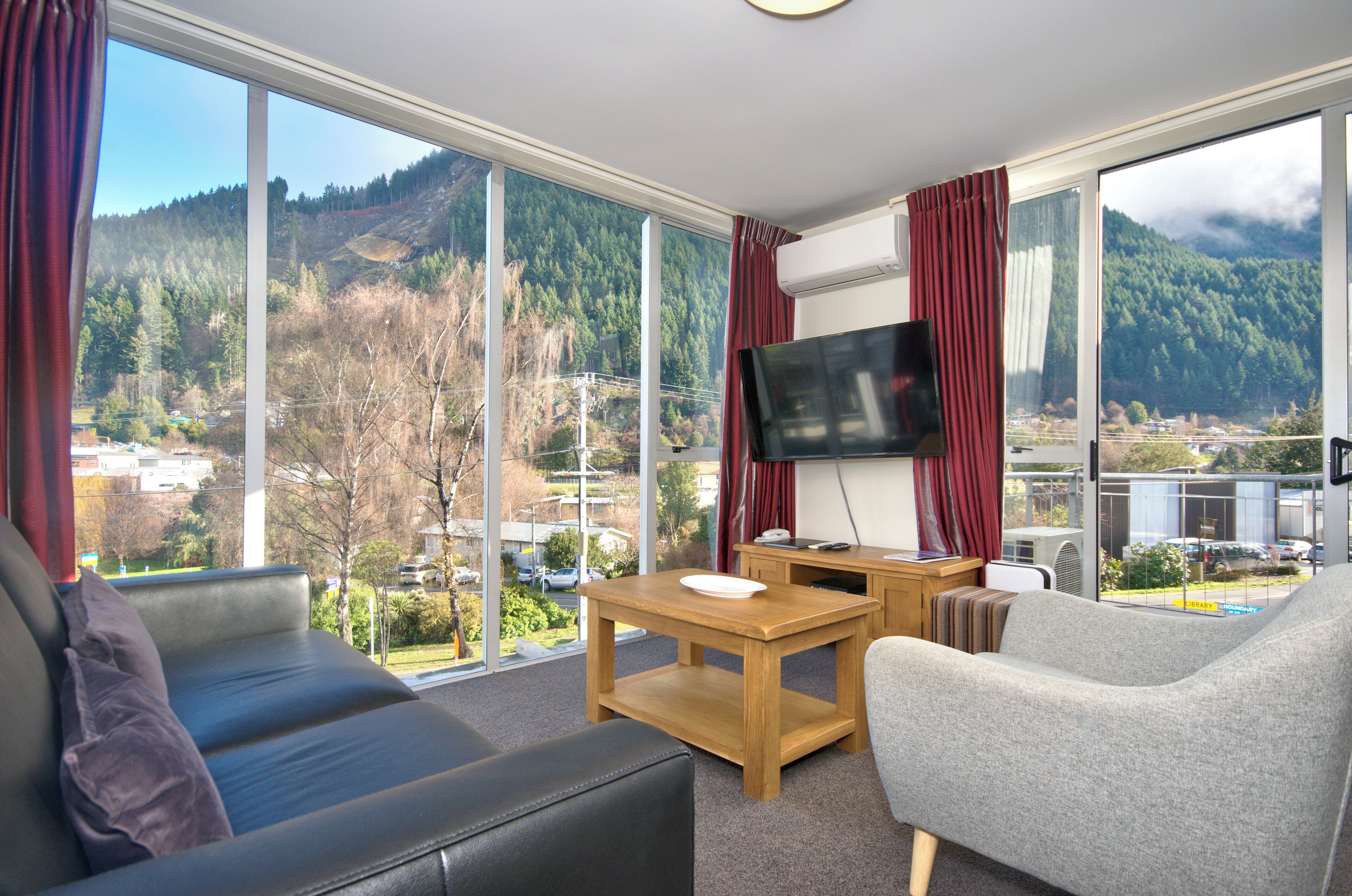 Deluxe One Bedroom Apartment | Living area | Flat-screen TV, DVD player