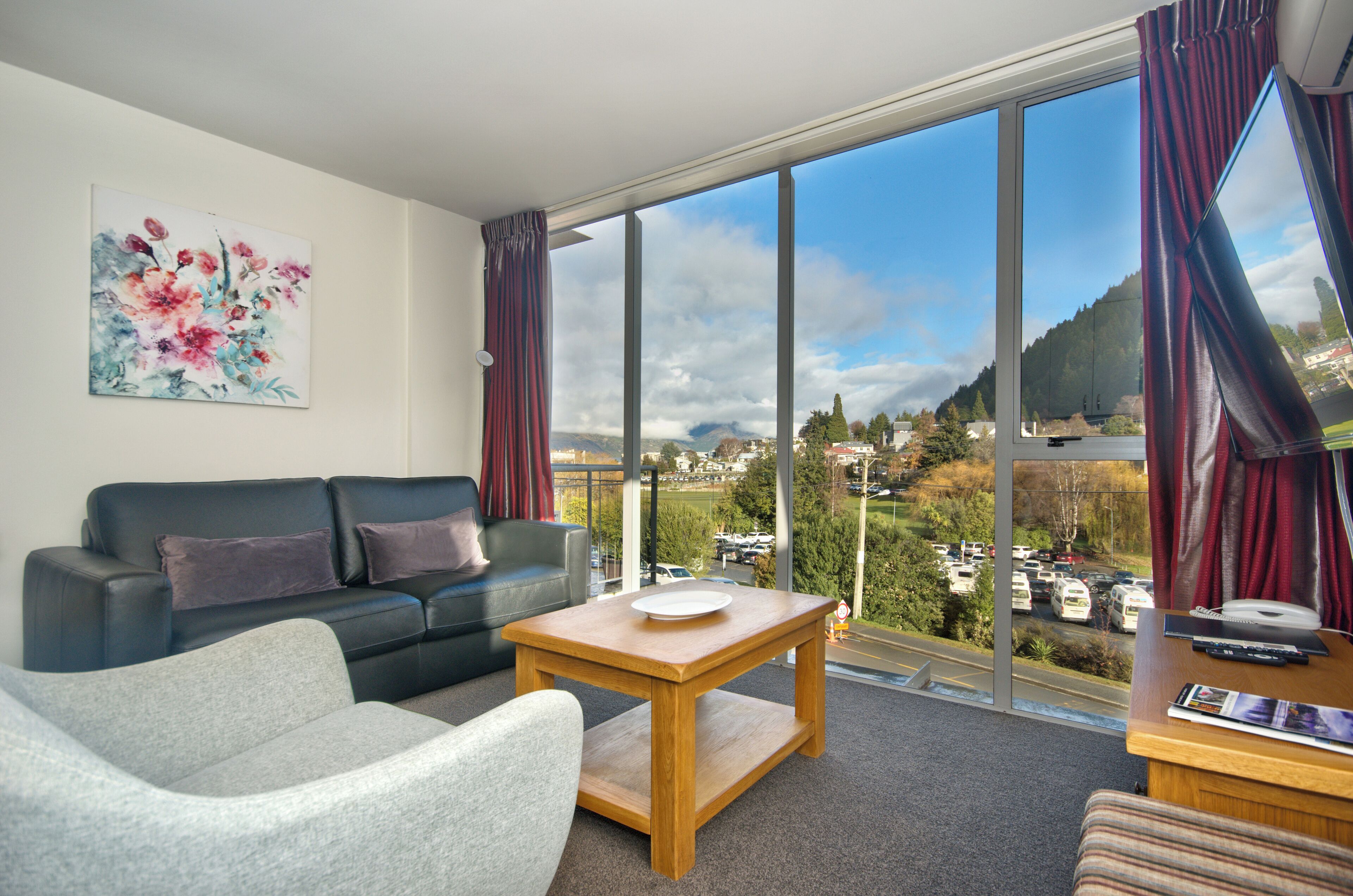 Deluxe One Bedroom Apartment | Living area | Flat-screen TV, DVD player