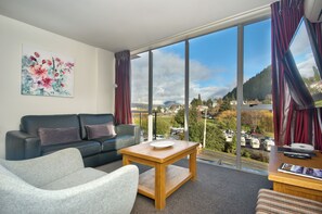 Deluxe One Bedroom Apartment | Living area | Flat-screen TV, DVD player - Whistler Holiday Apartments (Queenstown)