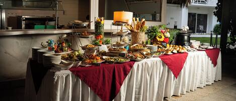 A buffet setup with various food items and a decorative centerpiece.