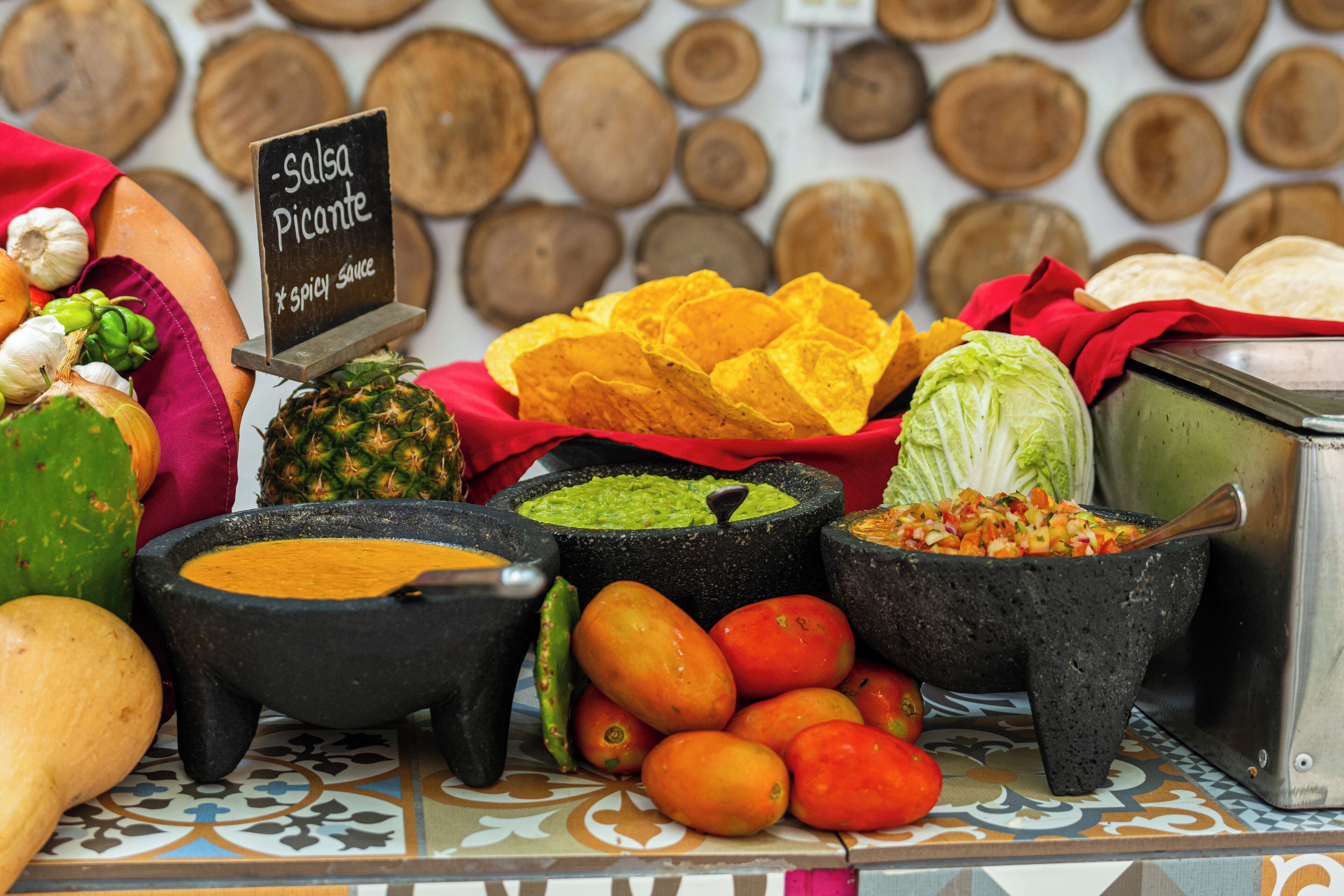 A variety of food items including a sign for 'Salsa Picante' and a display of tortillas.