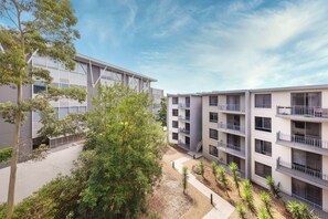 A multi-story residential building with balconies and a courtyard.