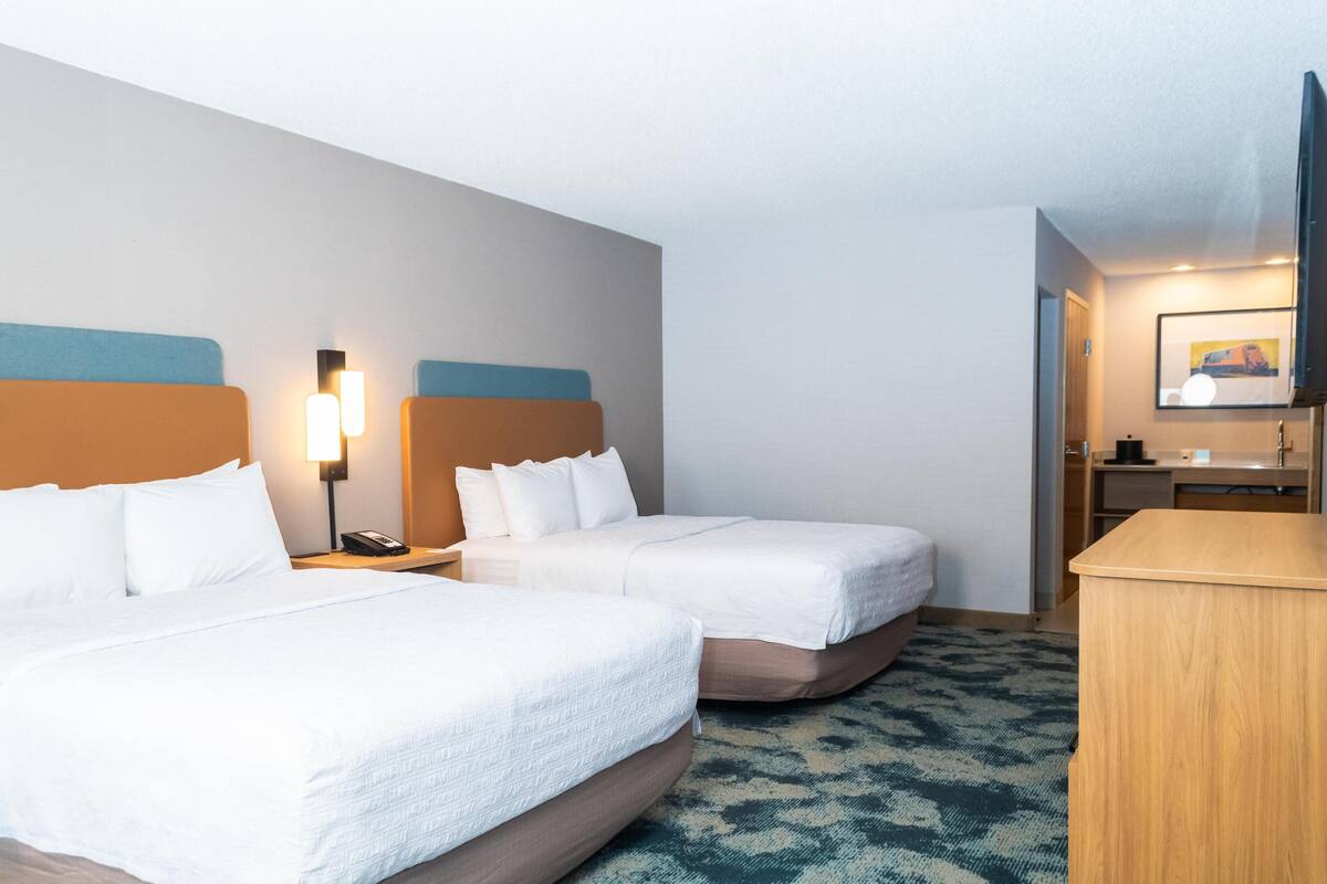 Premium bedding, desk, laptop workspace, blackout curtains
