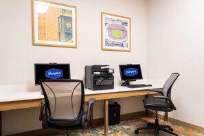 A hotel office with two monitors, a printer, and two office chairs. - Hampton Inn & Suites Addison (Addison)