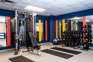 A gym with weightlifting equipment, exercise balls, and a mirror. - Hampton Inn & Suites Addison (Addison)