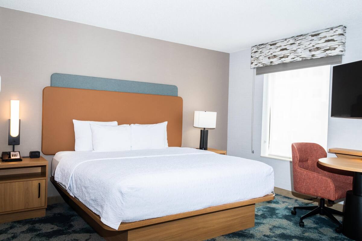 Premium bedding, desk, laptop workspace, blackout curtains