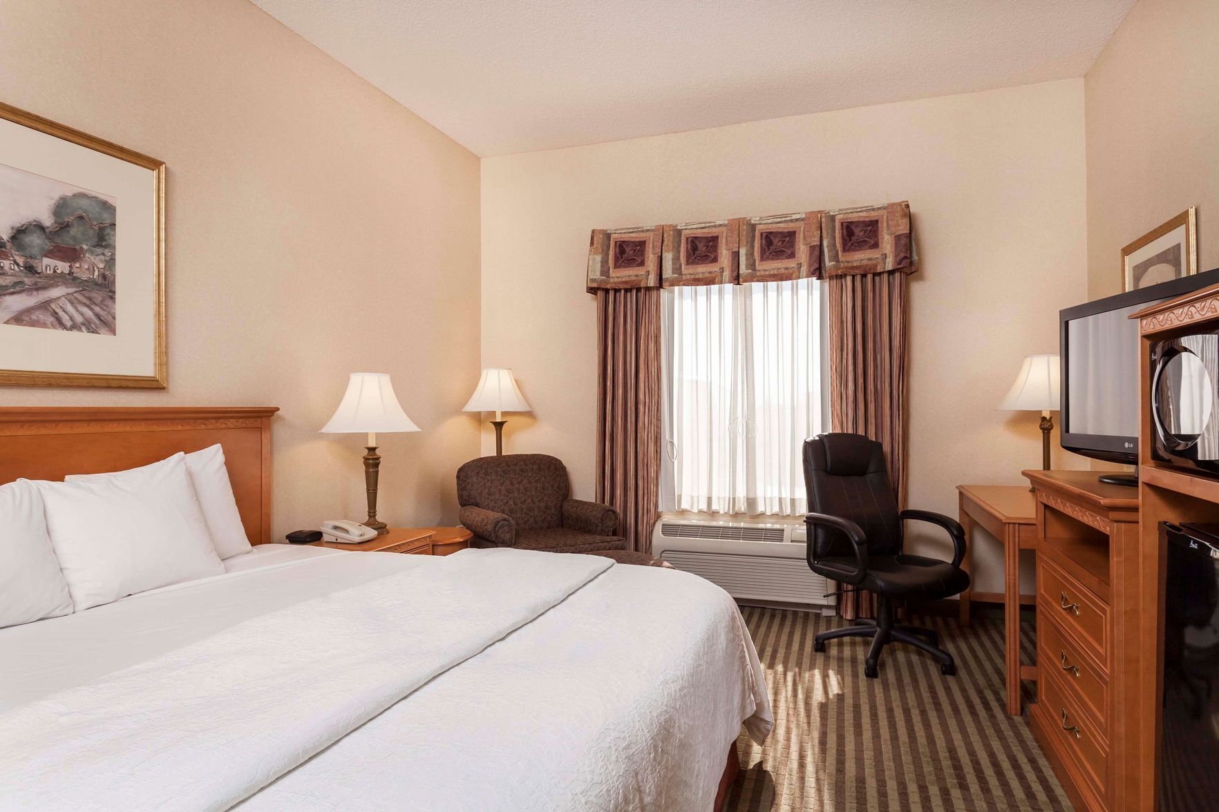 Premium bedding, desk, laptop workspace, blackout drapes