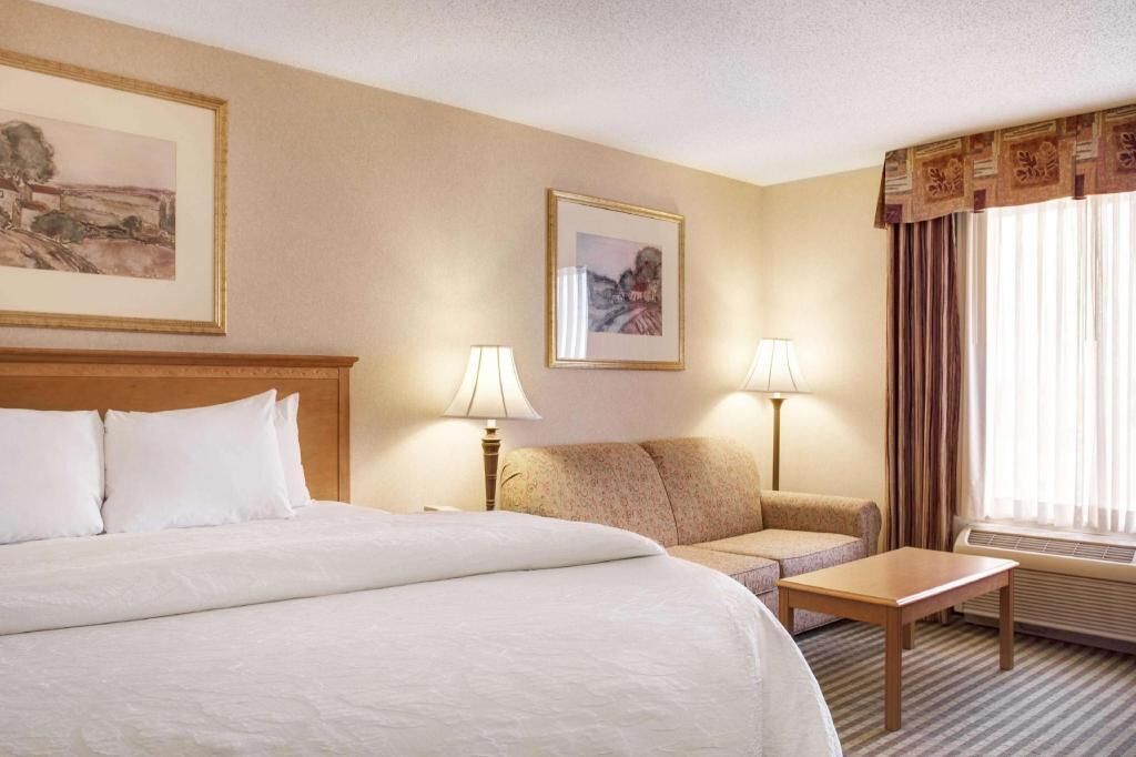 Premium bedding, desk, laptop workspace, blackout drapes