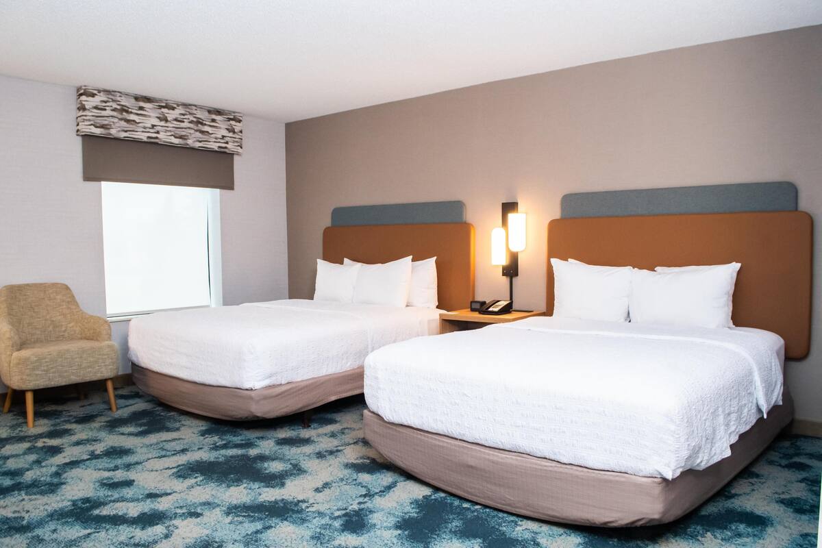 Premium bedding, desk, laptop workspace, blackout curtains