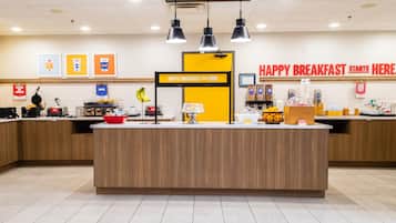A breakfast counter with a sign that reads 'HAPPY BREAKFAST STARTS HERE' and various food items and condiments available for purchase.