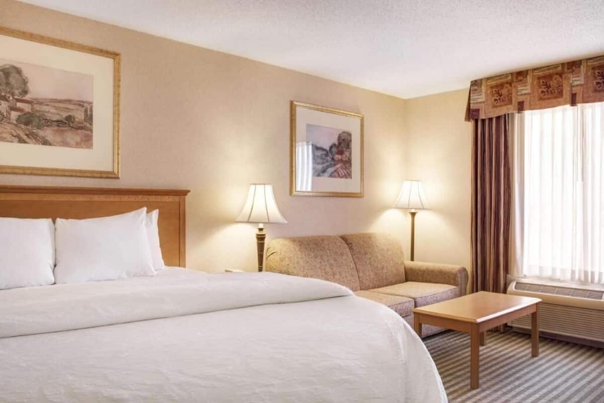 Premium bedding, desk, laptop workspace, blackout drapes