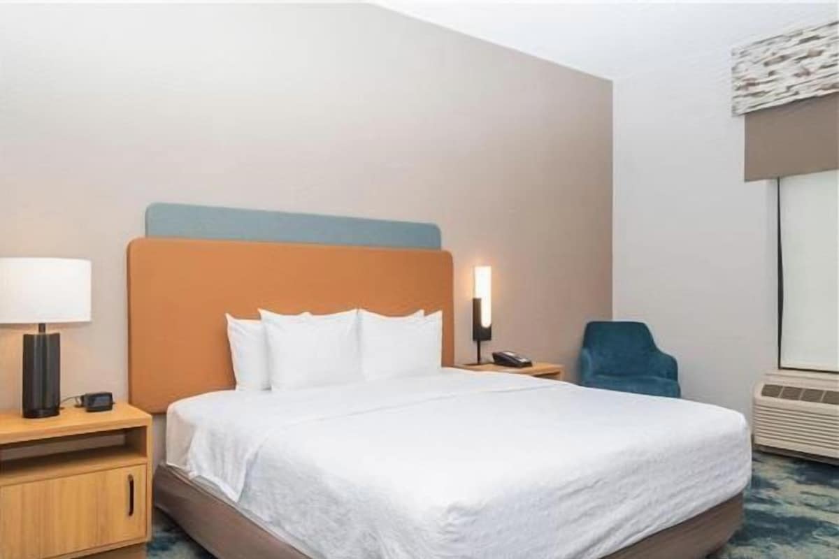 Premium bedding, desk, laptop workspace, blackout drapes