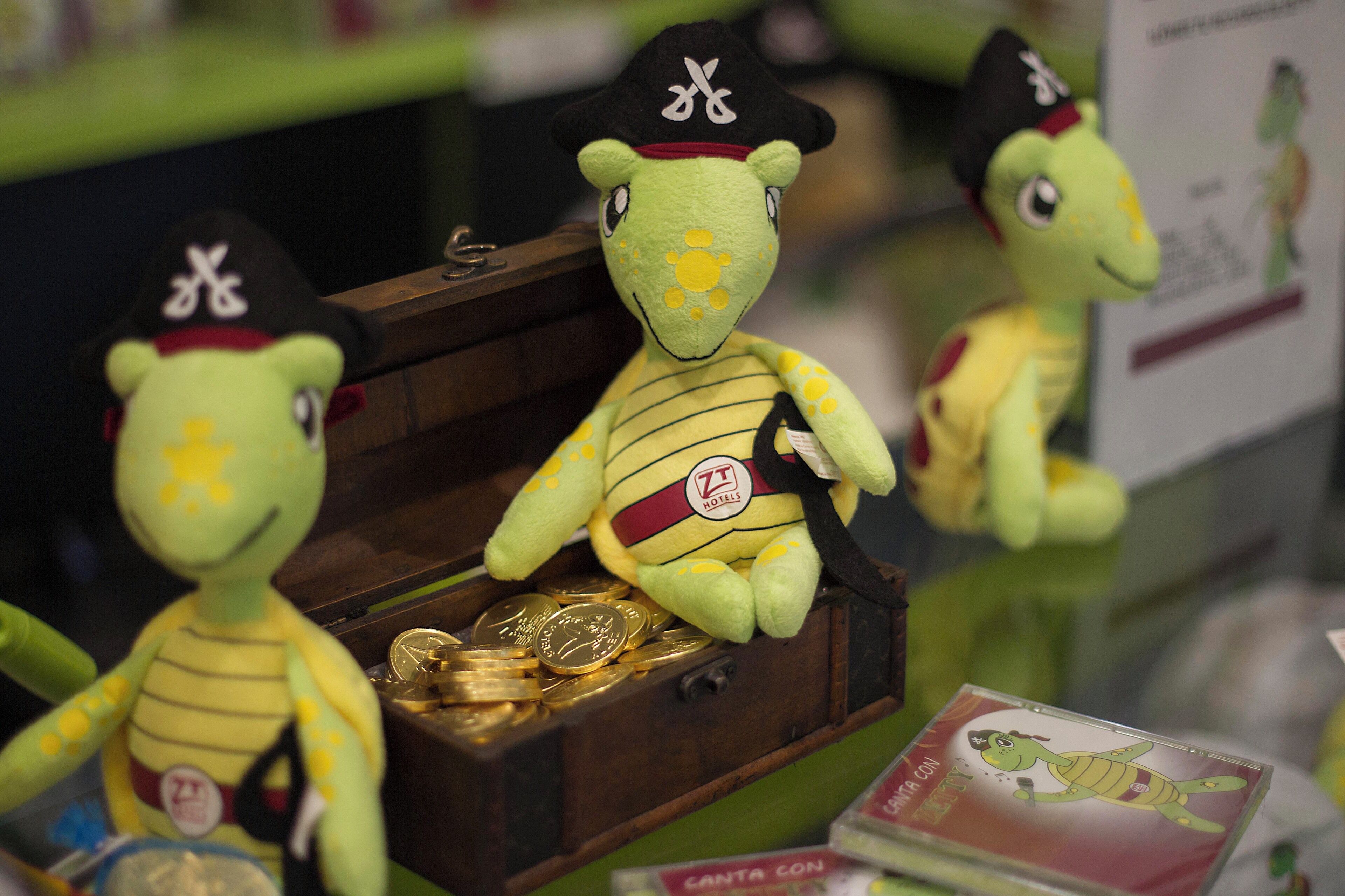 Plush toys in a wooden box with coins.
