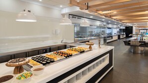 A buffet area with various food items and a pizza station. - Hotel & Spa Peñíscola Plaza Suites (Peniscola)