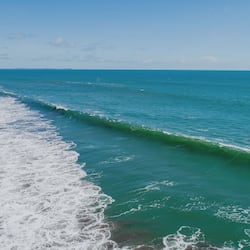 On the beach, black sand, free beach cabanas, sun-loungers