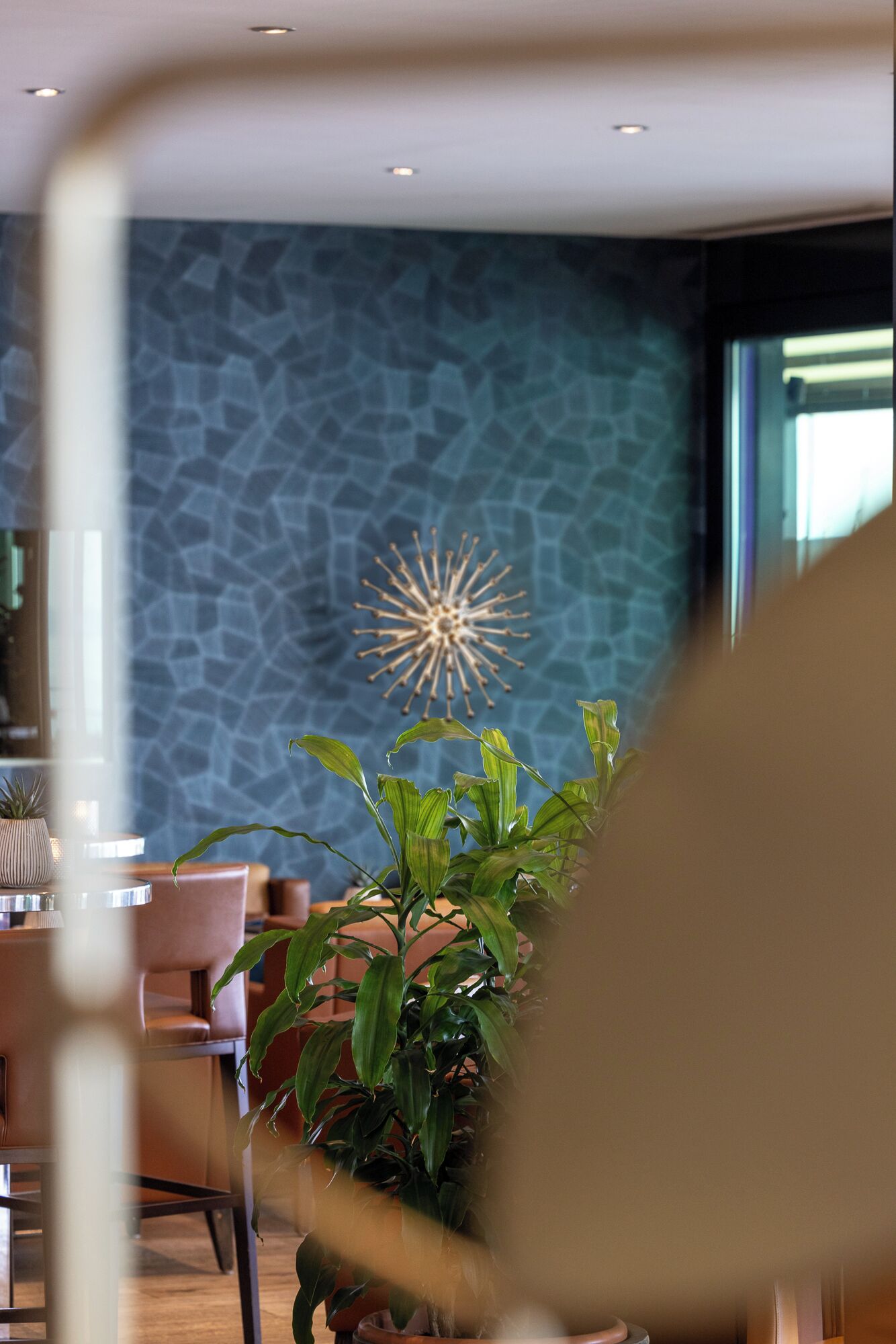 Un interior moderno con una pared de piedra, una lámpara decorativa y una planta en maceta.