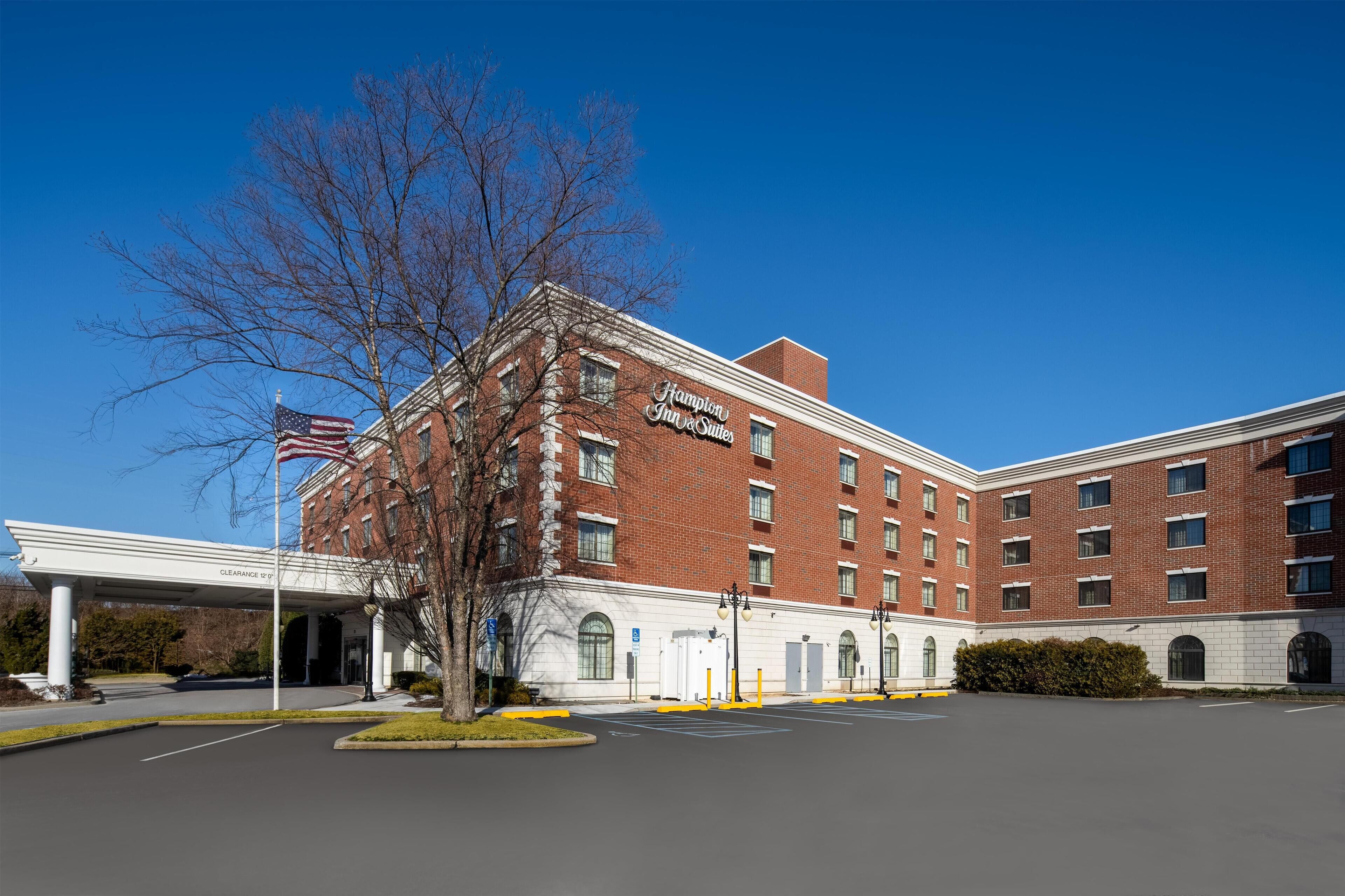 A large brick building with a sign reading "Champion Inn & Suites."