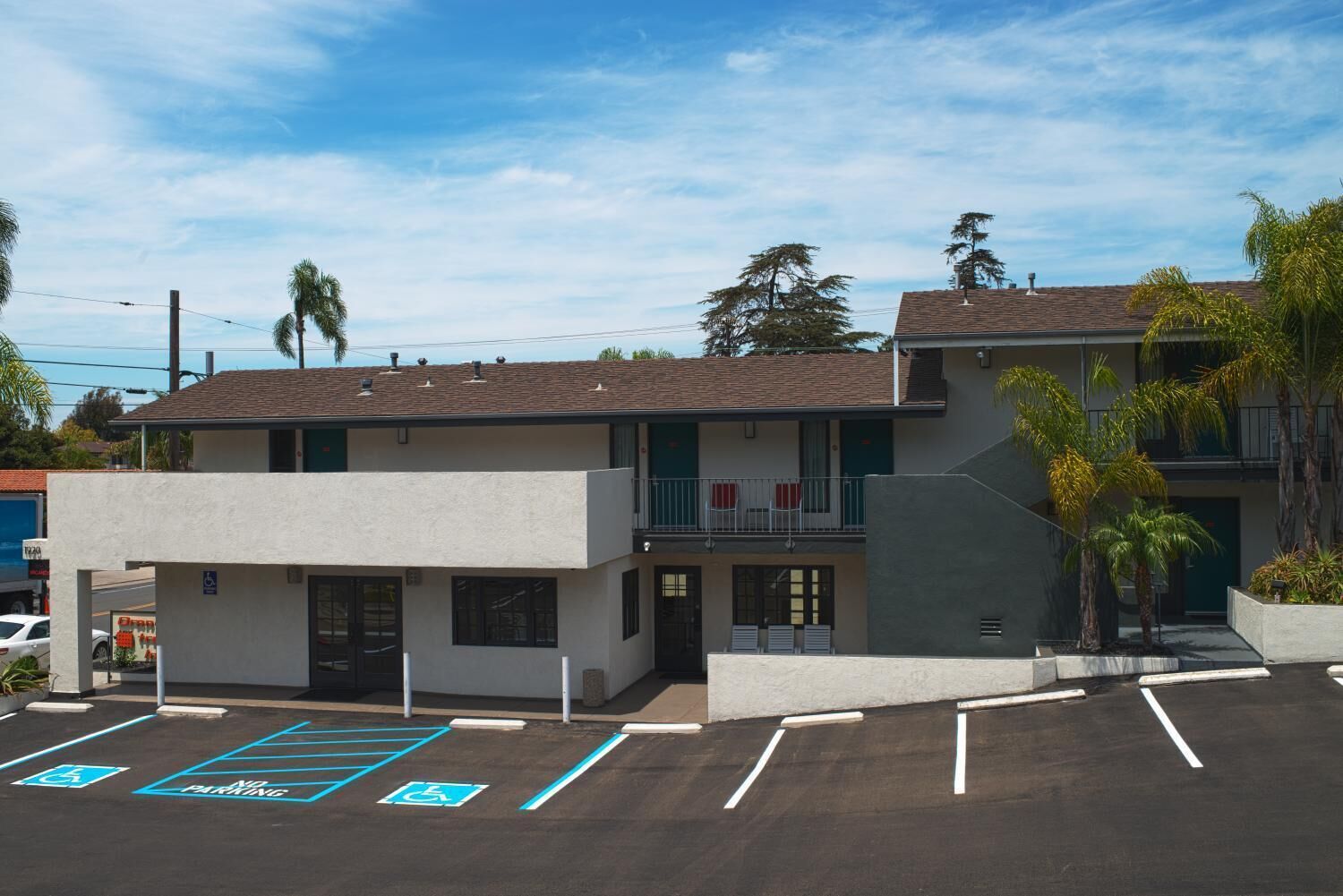 A two-story building with a parking lot in front, including designated handicapped parking spaces.