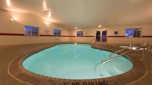 An indoor swimming pool with a '3FT NO DIVING' sign, surrounded by windows and equipped with metal ladders. - Super 8 by Wyndham Greenfield (Greenfield)