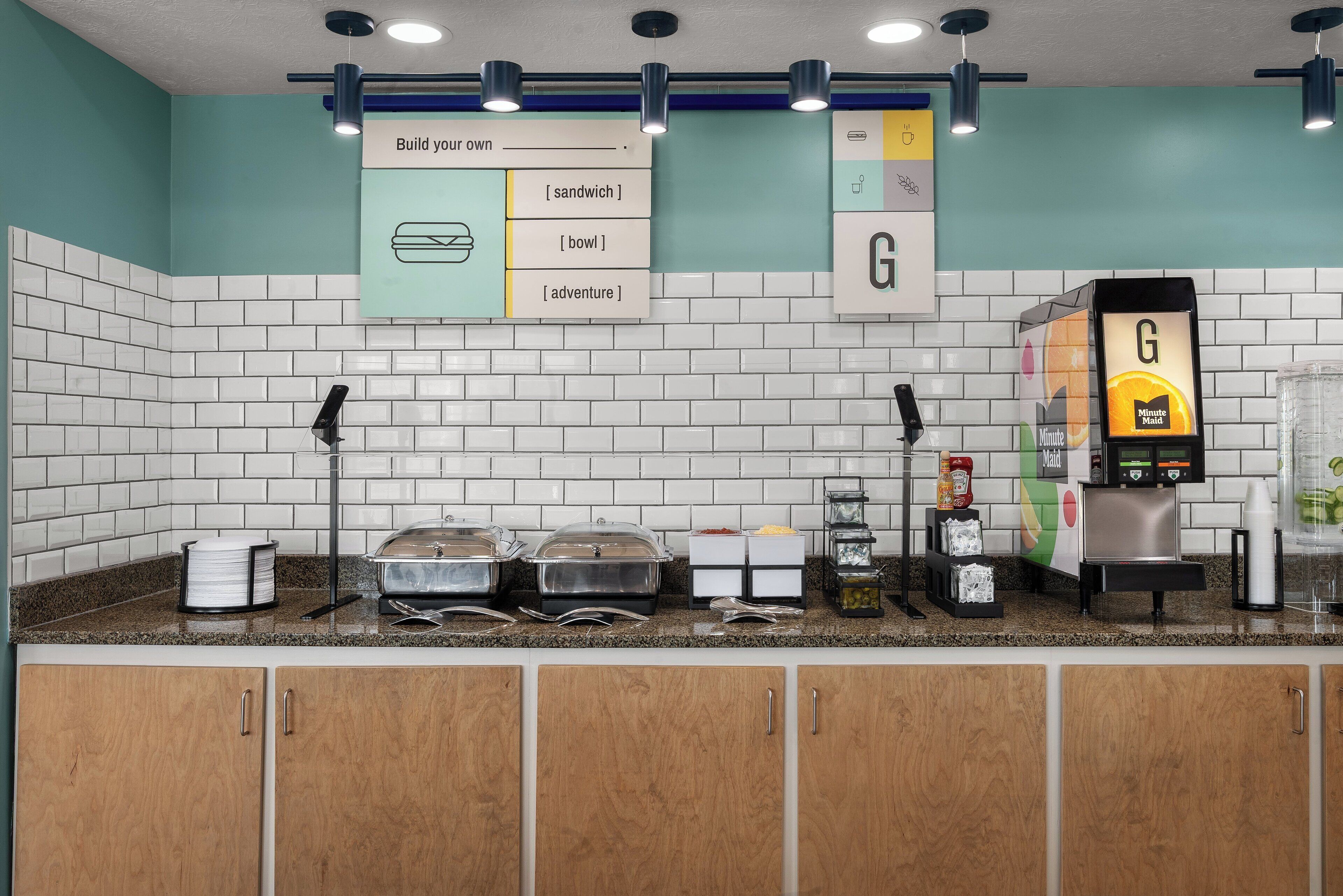 A breakfast bar with a menu board, self-serve beverage station, and food containers.