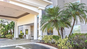 A modern building entrance with a clear sign indicating a 13' clearance.
