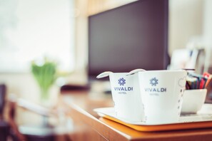 Two white Vivaldi Hotel branded cups on a tray. - Vivaldi Hotel (Poznan)