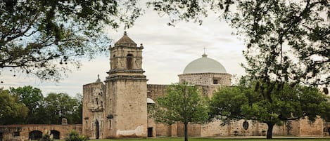 An old stone building with a bell tower and a dome.