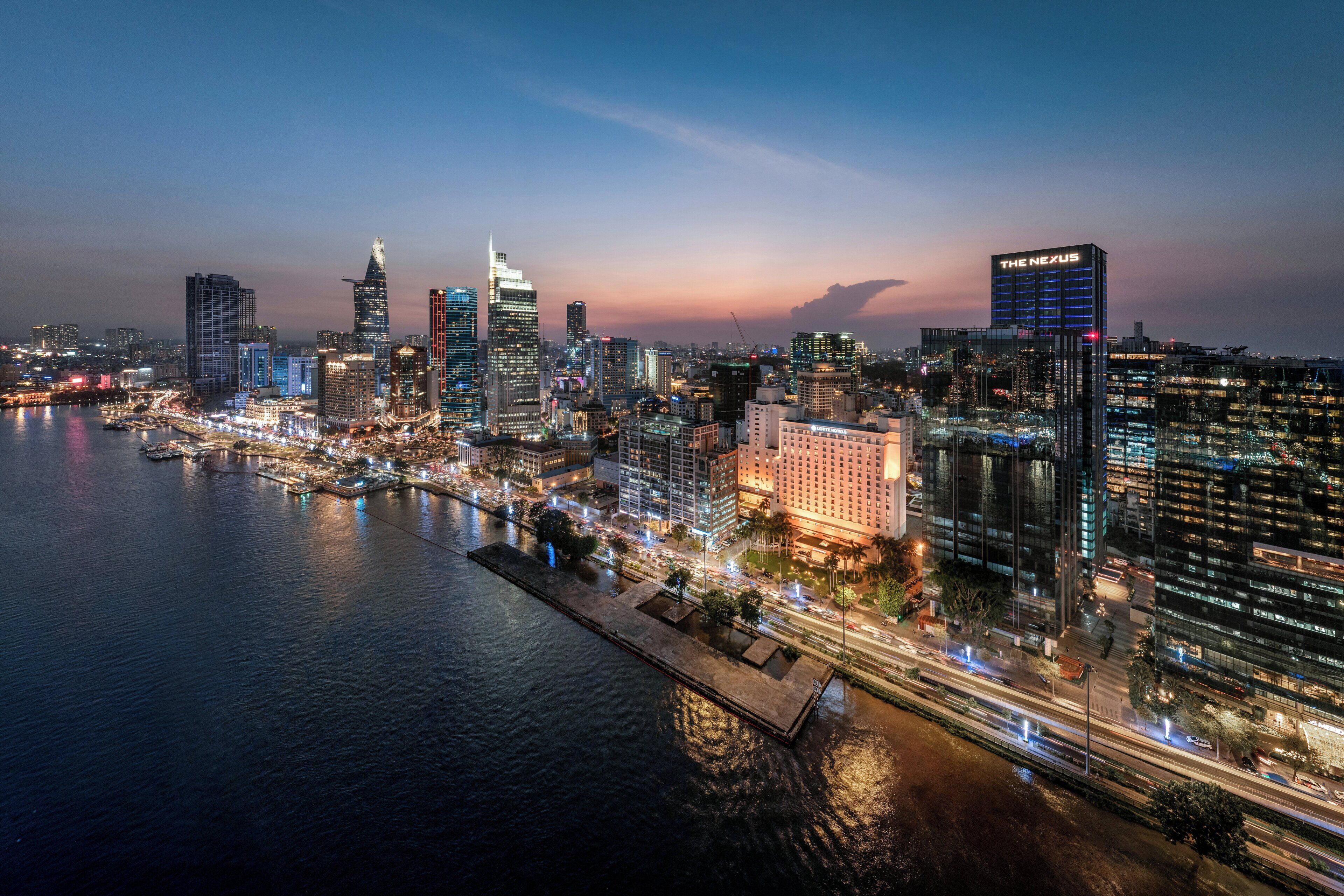 A city skyline with prominent high-rise buildings, including 'The Nexus.'