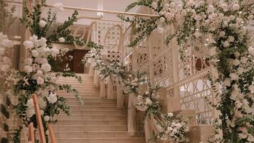 A staircase with white floral decorations and a wooden railing.