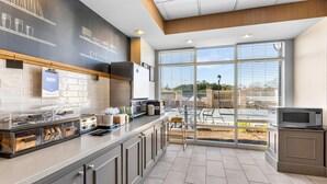 A modern kitchen with a large window, a counter with appliances, and a view of the outdoors. - Hampton Inn Guntersville (Guntersville)