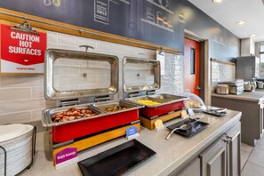A buffet area with labeled food stations including maple sausage, scrambled eggs, and redskin potatoes. - Hampton Inn Guntersville (Guntersville)
