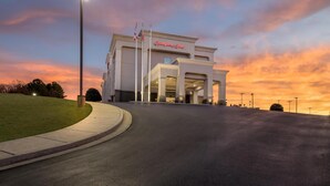 A hotel with a prominent entrance, a well-lit driveway, and a clear sky at dusk. - Hampton Inn Guntersville (Guntersville)