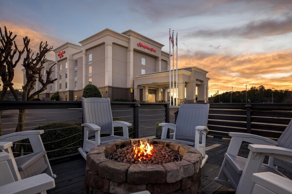 A hotel with outdoor seating and a fire pit.