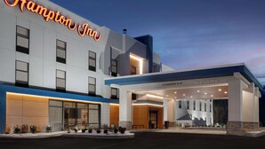 A modern Hampton Inn hotel with a clear entrance, a neon sign, and a welcoming 'Welcome' sign above the entrance. - Hampton Inn Bloomsburg (Bloomsburg)