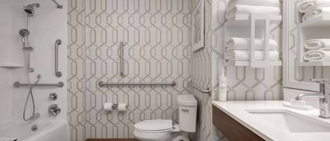 A modern bathroom with a shower, toilet, and sink.