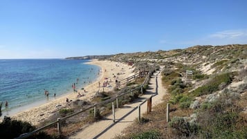 Beach nearby, white sand, beach towels
