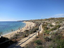 Beach nearby, white sand, beach towels